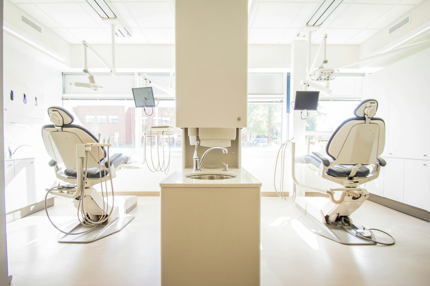 Bright modern treatment room with two dental chairs